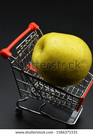 yellow apple in the shopping cart

