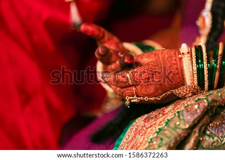 Beautiful Indian bride hand with mehandi design and jewelry 