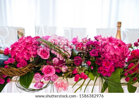 Beautiful wedding set decoration in the restaurant. Flowers on table of newlywed.