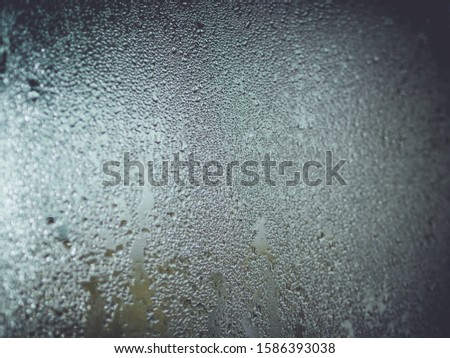 Water droplets condensation background of dew on glass, humidity and foggy blank. Inside open the air conditioner