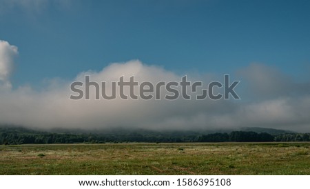 Morning clouds in the meadow. Landscape in the countryside. Summer season, July. Web banner. Ukraine. Europe.