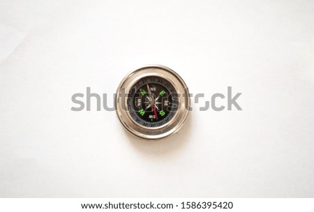 
Compass in a metal frame on a white background. View from above.