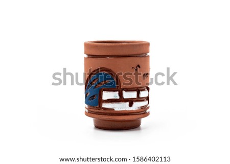 A piece of Egyptian pottery decorated with white and blue patterns on a white background