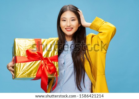 Gift box blue background woman in coat and Christmas New Year