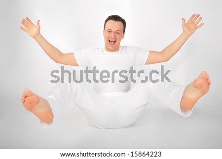 man in sports suit, fallen back with hands dissolved in sides