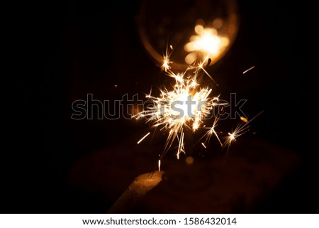 Bengal fire and sparks macro photo festive bokeh background Christmas and New Year