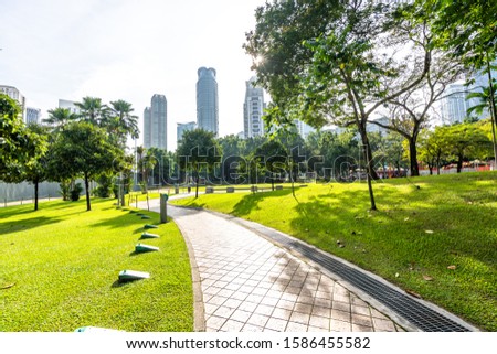 city skyline with green lawn in kuala lumpur