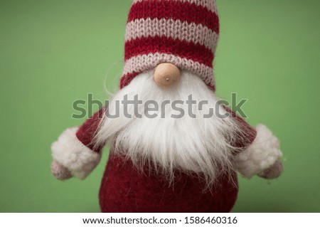 Closeup of christmas gnome on green background 