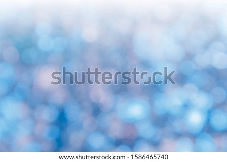 Abstract Blue Bokeh with soft blurred background nature blurry light party in vintage style warm pastel shimmering and faded cool colorful defocused circular. Shiny copy space for holiday card. 