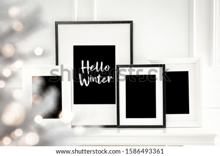 White frames of free space for your decoration and chrsitmas time.Fireplace shelf and white wall background.Sun light from window and shadows. 