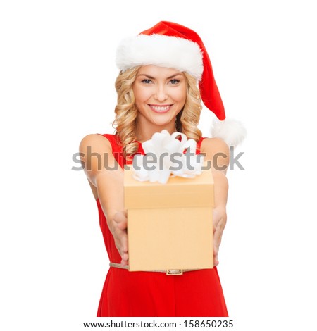 christmas, x-mas, winter, happiness concept - smiling blonde woman in santa helper hat with gift box