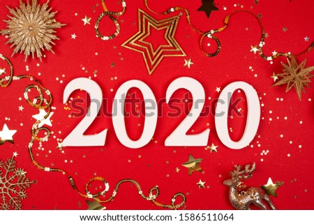 2020 on red background with sparkles. Flat lay style.
