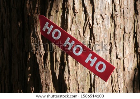 Red tag with Ho ho ho, Santa's laugh on a Christmas tree