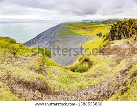 Panoramic picture of black Reynisfjara beach from Dyrholaey outlook in southern Iceland in summer