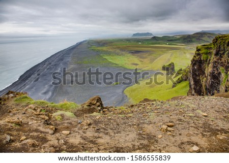 Panoramic picture of black Reynisfjara beach from Dyrholaey outlook in southern Iceland in summer