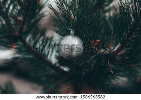 Beautiful green Christmas tree decorated with balls and garlands. Close-up photo. 