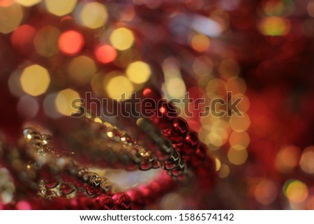 New Year’s shiny flickering beads,
christmas vibrant decor details macro photo bokeh lights