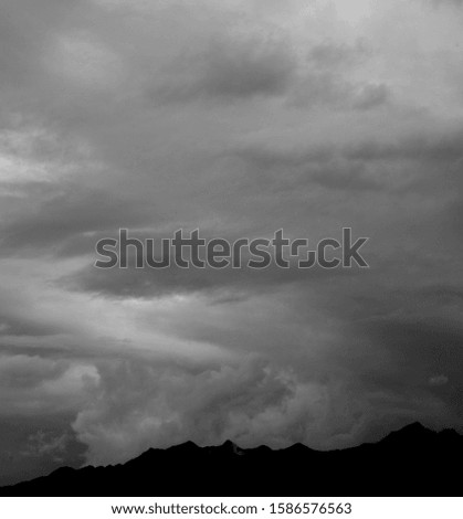 Rain clouds and thunderstorm clouds hang over the mountains of South Tyrol - Bad weather front and bad weather forecast