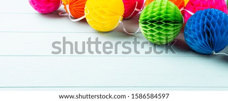 Festive blue background with colorful paper balls. Greeting card concept voor birthday, party, invitation, carnival. Copy space, banner