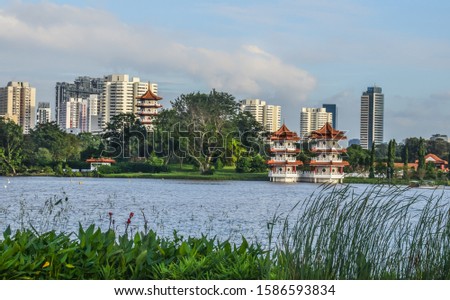 A view of Singapore Chinese Garden as seen across Jurong Lake from Jurong Lake Gardens. The three pagodas at the garden are in the picture. In the background are buildings in Jurong East.