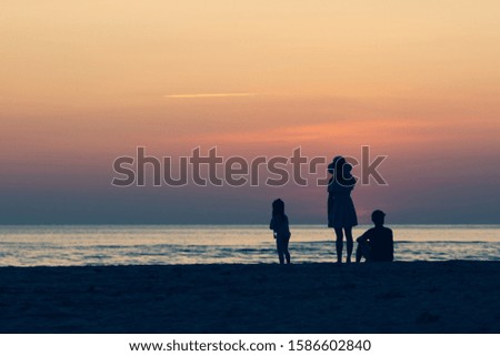 A family of three father mom and child
At sea on vacation Silhouette style A happy family