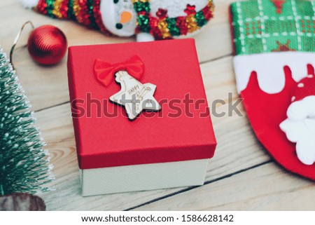 Close up red gift box on wood table, merry christmas and happy new year, boxing day sale, hello holiday season concept