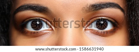Letterbox view of black woman eyes close-up Royalty-Free Stock Photo #1586631940