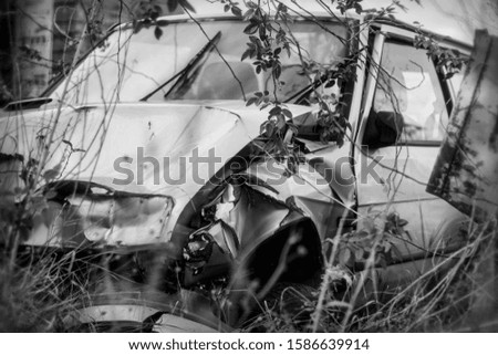 Photo of damaged and rusty car after crash.