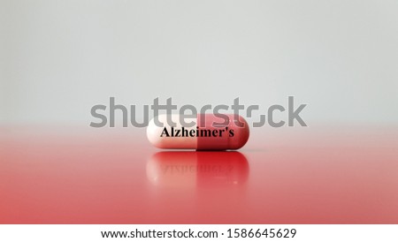 Capsule of medicine for treatment Alzheimer's disease. Alzheimer cause brain cells degeneration that lead to memory loss (dementia disorder). skills. Neurology and medical technology concept.