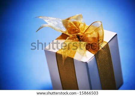mood shot of luxurious gift box on blue background - intentional selective focus & vignetting