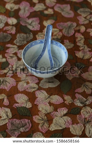 Empty white ceramic bowls on wooden background