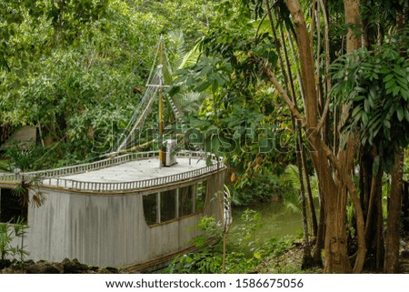 
Abandoned white boat on a river in the Amazon rainforest in Brazil