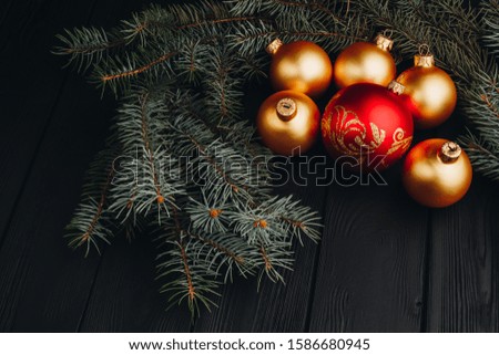 Colored christmas decorations on black wooden table. Xmas balls on wooden background. Top view, copy space. new year
