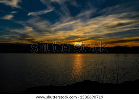 Quiet surface of the lake at sunset