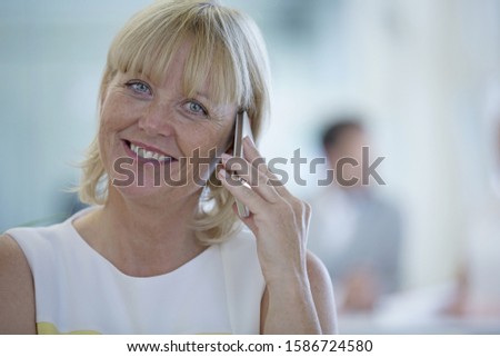 Portrait Of Businesswoman Making Phone Call In Modern Office