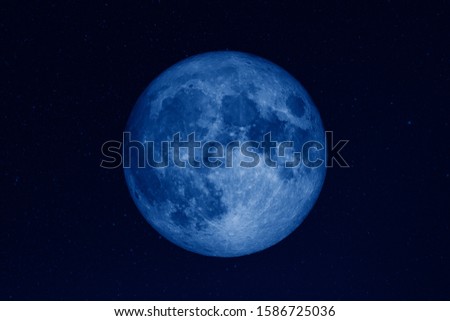 huge full moon in dark starry space toned in trendy pantone Classic Blue color of the Year 2020. Elements of this image furnished by NASA