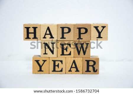 Word Happy new year on wooden cubes.white background.