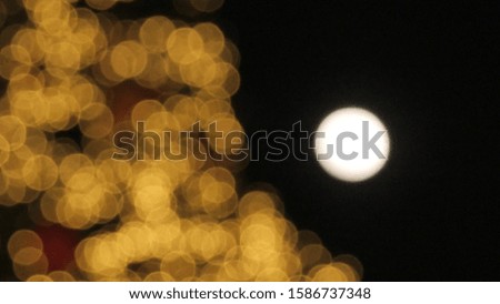A Christmas or celebration bokeh background and copy space. Bokeh light in the party with the moon.