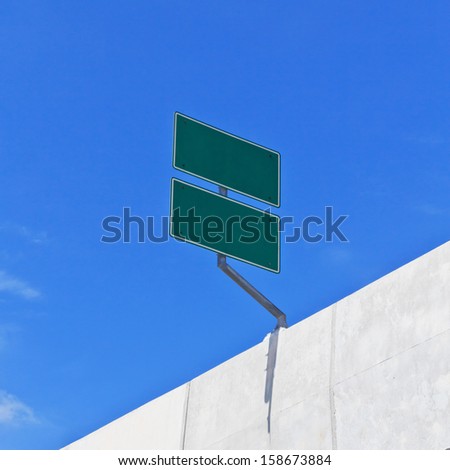 Road Sign on concrete bridge with blue sky blank for text