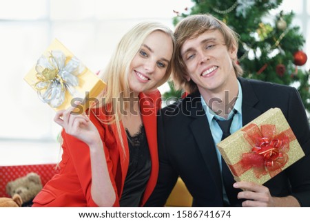 Young couple are happy to celebrate Christmas in the house, Merry Christmas.