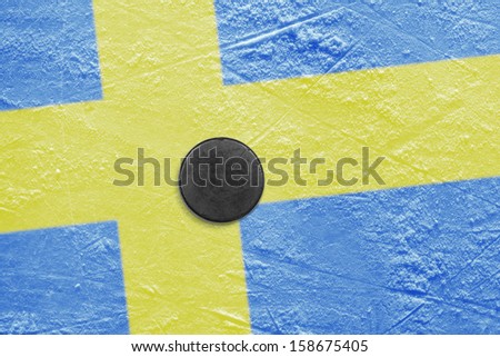 Puck and a Swedish flag image on the hockey rink