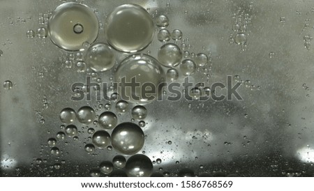 The circle from oil drops on the water surface is used as a dark background image.