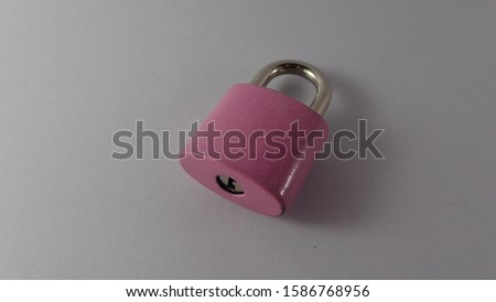 Pink iron padlock on a white scene