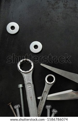 Work tools in a creative composition. Decorative image. Wrenches and screws in the form of cut grass. Animated objects. Tools. Steel tools decor.