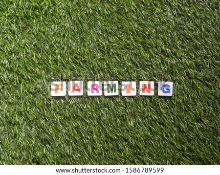 Word Farming on faux green grass background