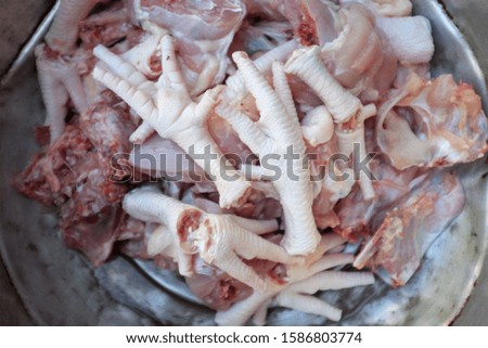 close up fresh Chicken and chicken feet in a stainless steel pot for cooking