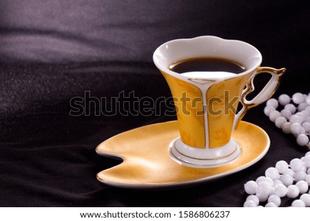A cup of coffee on a dark background with Christmas decorations