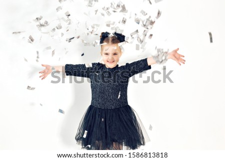 Party, holidays, new year and celebration concept - child throwing confetti.
