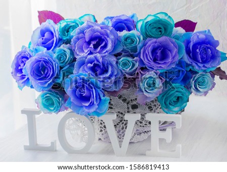 in a basket a bouquet of pantone roses and the word love
