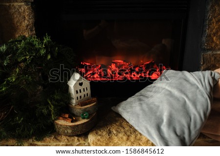 white toy house on electro fireplace background